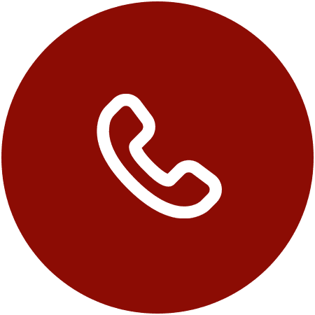White telephone icon on a circular red background.